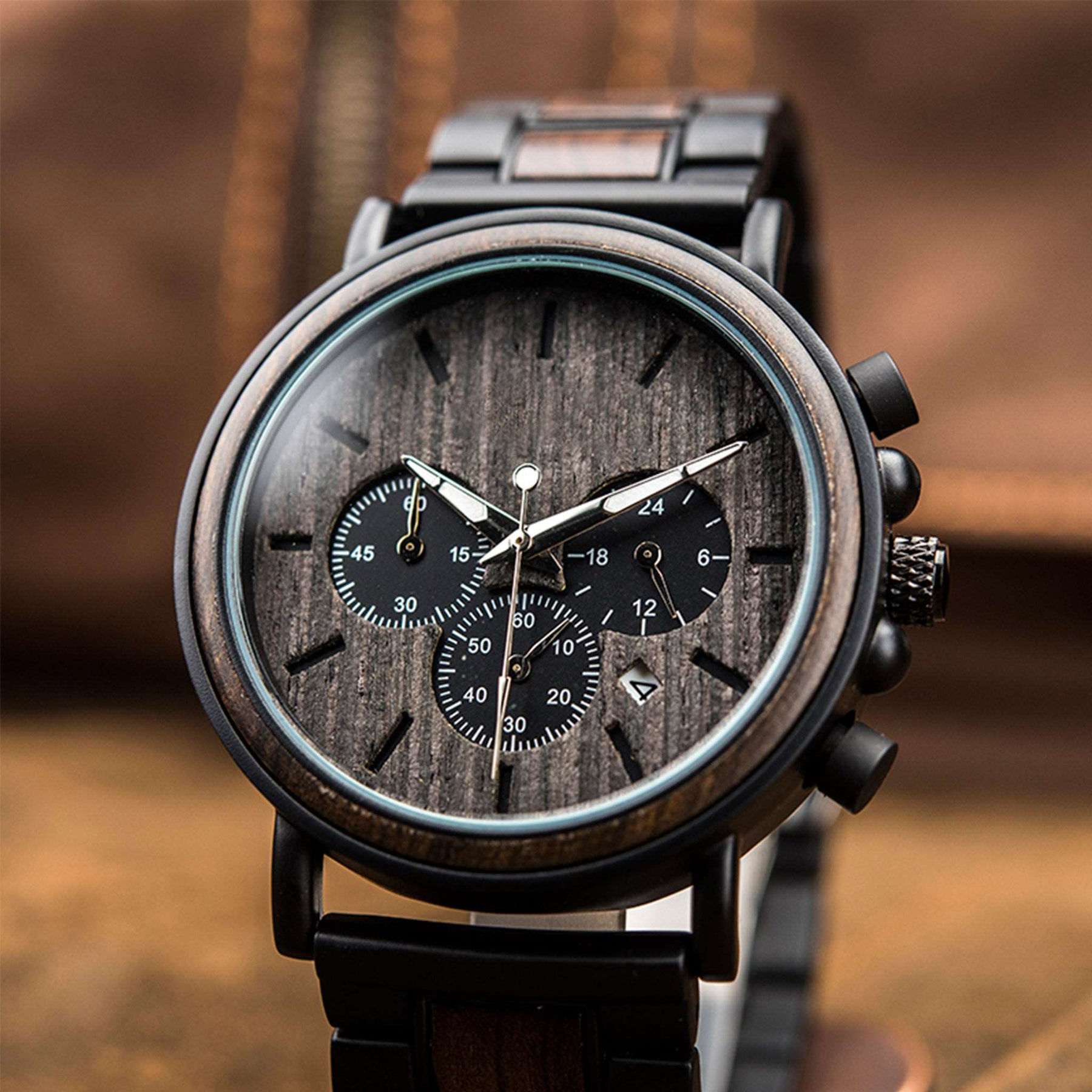 The black wooden face of the black metal and ebony men chronograph