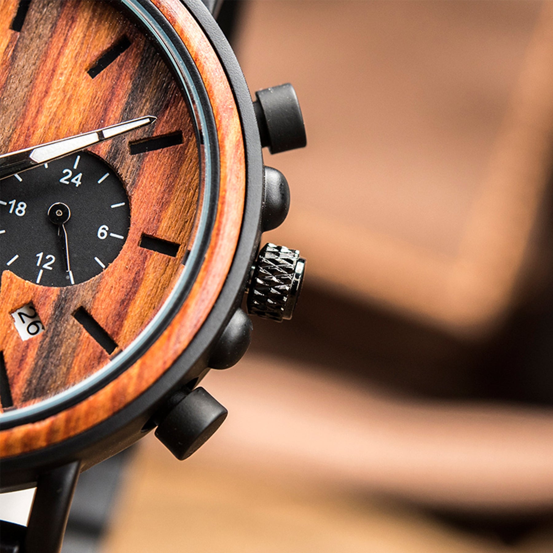The black crown and buttons of the black metal and red sandalwood men watch