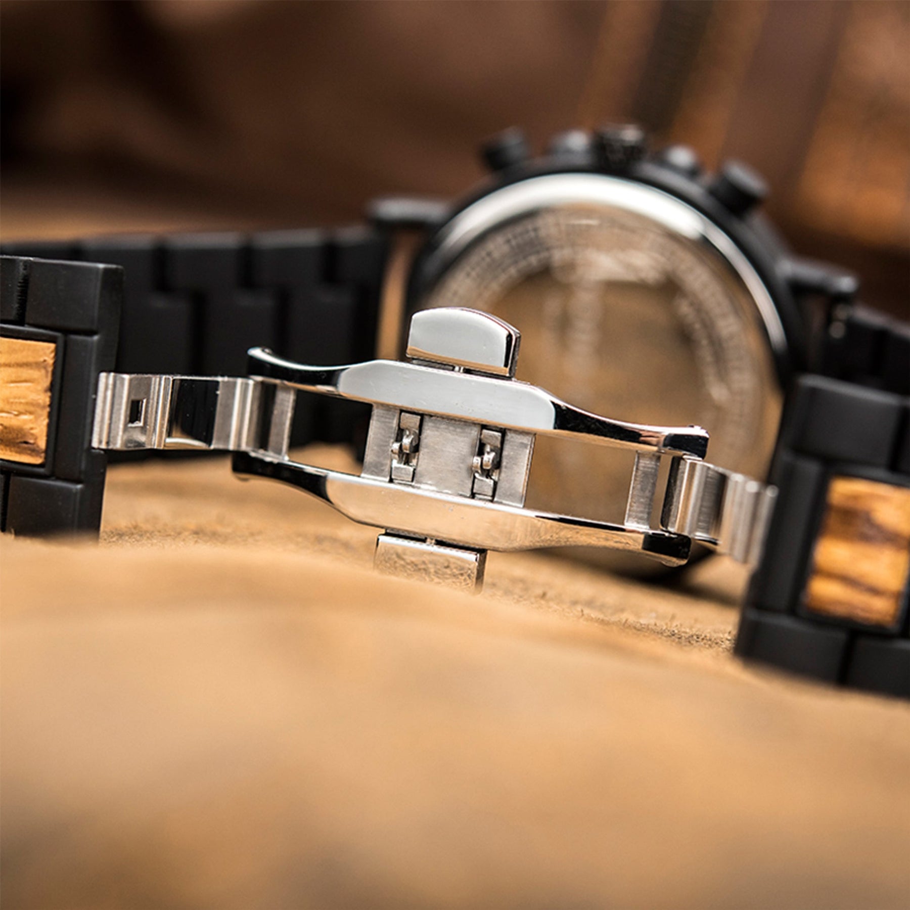 The silver butterfly clasp of the black and red sandalwood men watch
