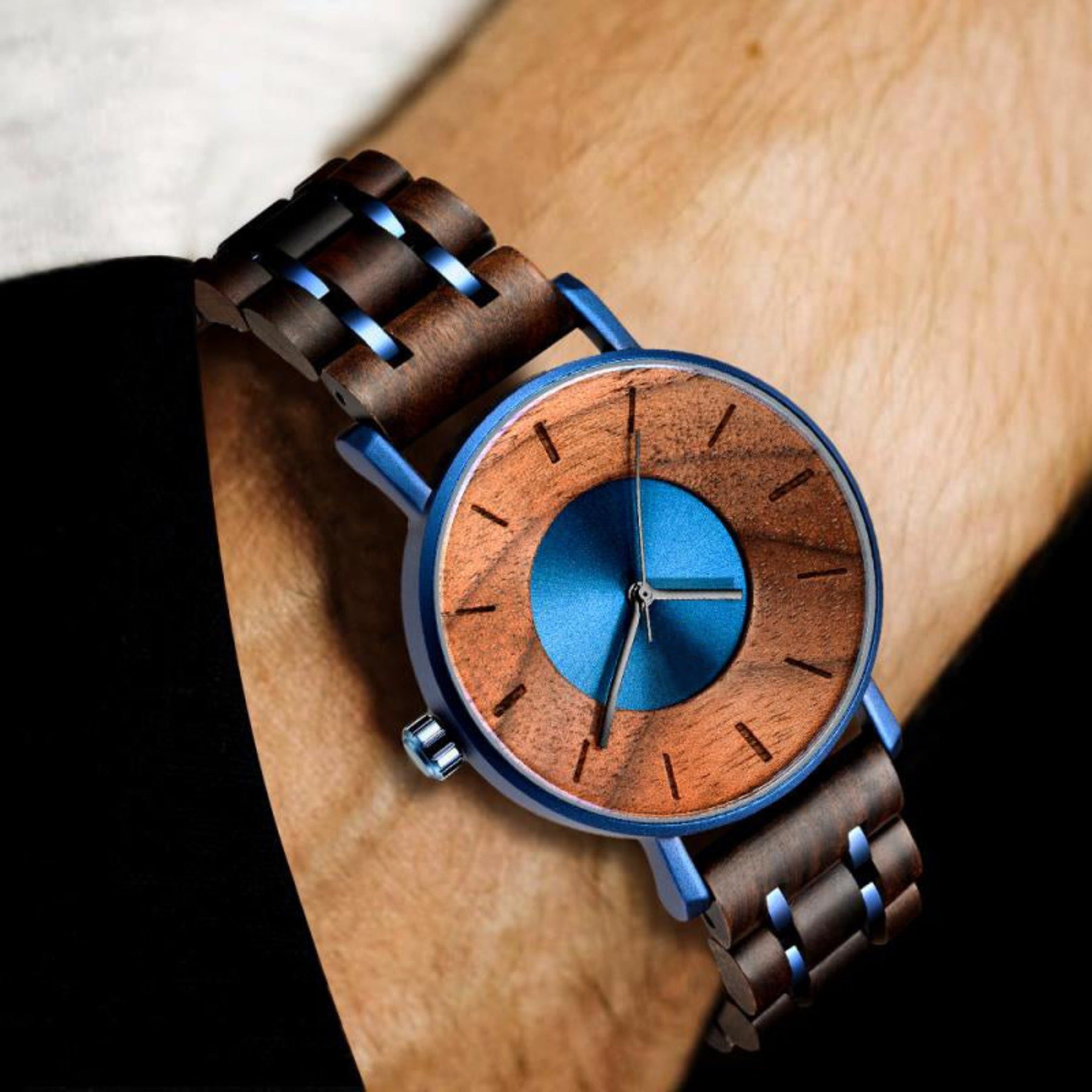 A man wearing a blue metal case walnut wood watch