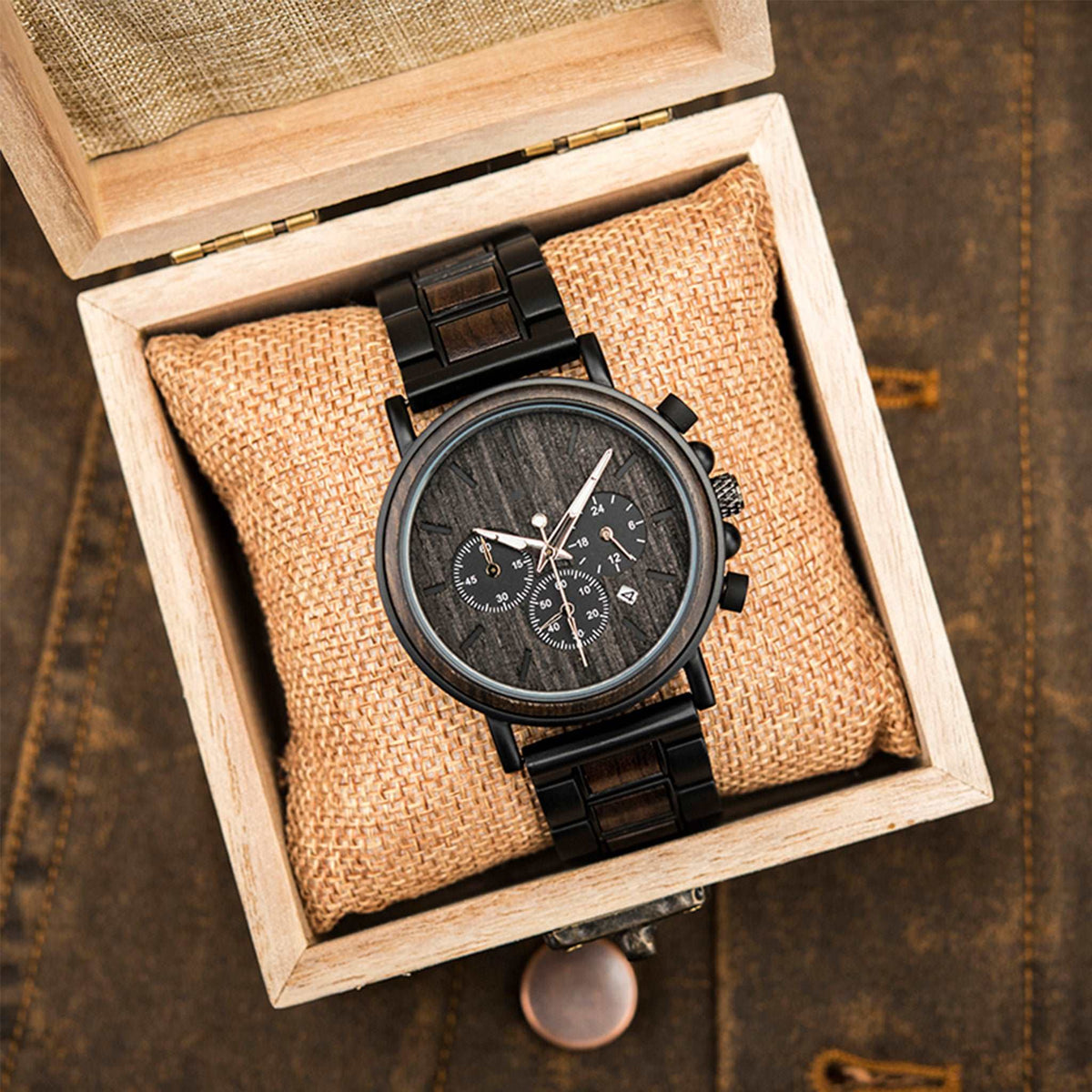A black metal and ebony men wooden watch packed up with square wooden box
