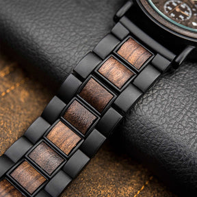 The black metal and ebony bracelet lying on the table