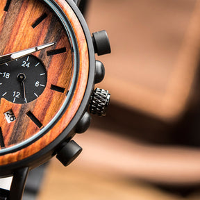 The black crown and buttons of the black metal and red sandalwood men watch