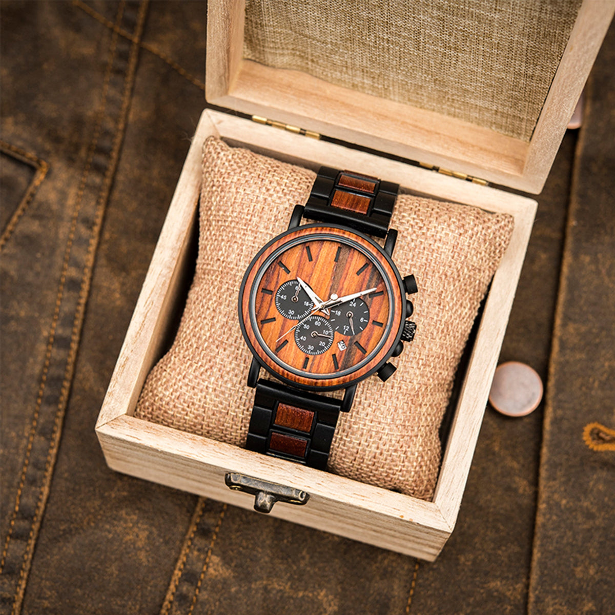 A black metal and red sandalwood men chronograph packed up with a square wooden box