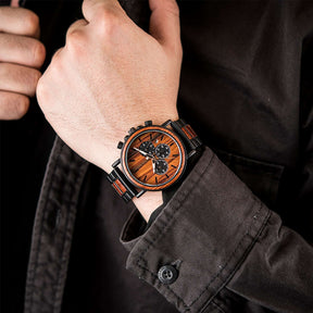 A man wearing a black metal and red sandalwood chronograph watch with red face