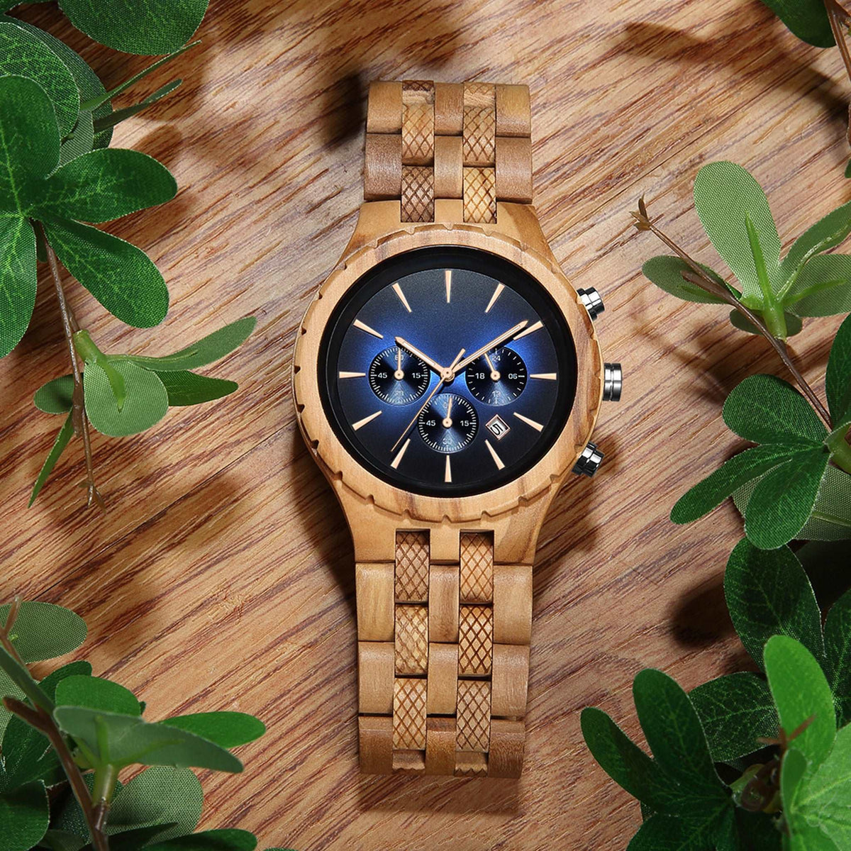 A olive skeleton men watch with blue face lying on the wooden table